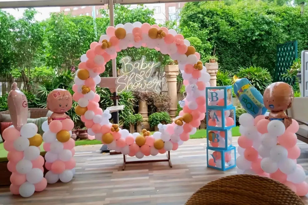 Open-air circular balloon ring decoration for a baby shower in Jaipur with a neon sign, balloon pillars, and block boxes by Shava Moments.