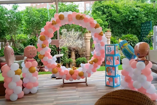 Open-air circular balloon ring decoration for a baby shower in Jaipur with a neon sign, balloon pillars, and block boxes by Shava Moments.