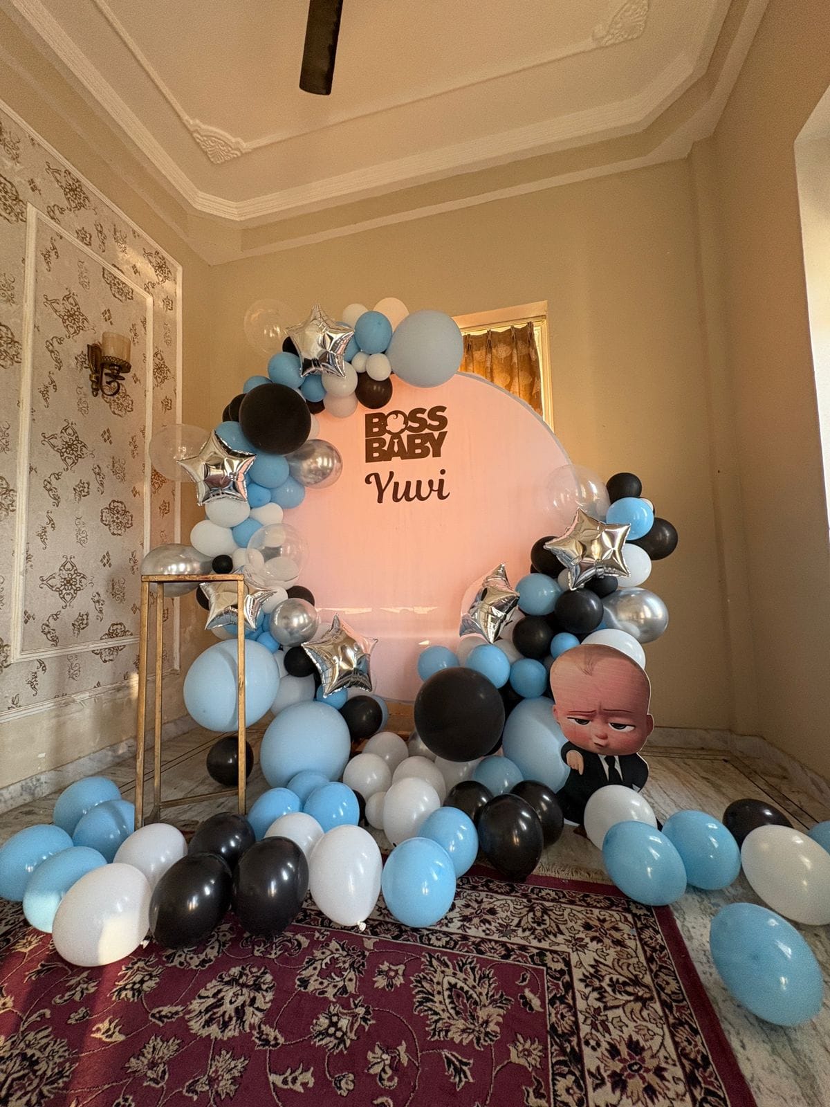 Modern Boss Baby themed birthday decor with blue, black, and silver balloons and custom round backdrop by Shava Moments Jaipur.