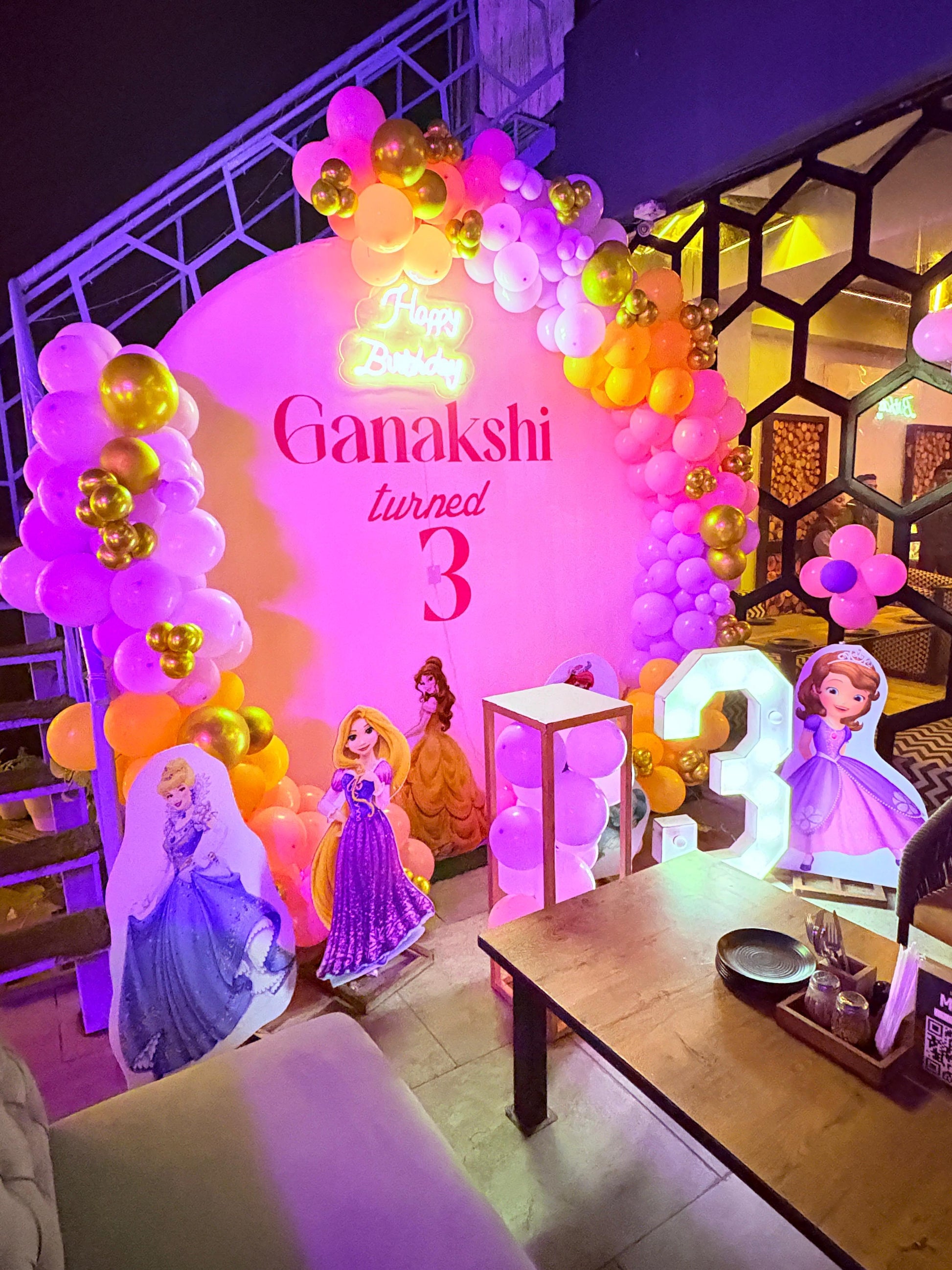 Disney Princess theme 3rd birthday decoration in Jaipur featuring a pink arch backdrop, neon sign, and Cinderella, Rapunzel, and Sofia cutouts by Shava Moments.