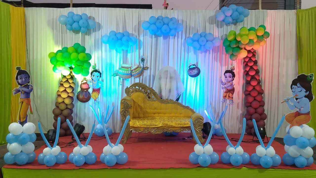 Immersive Bal Krishna Kanha garden-themed naming ceremony stage in Jaipur with balloon trees and cloud ceiling by Shava Moments.