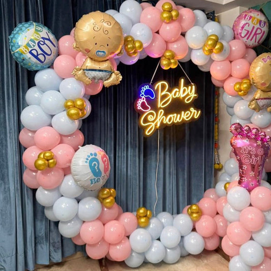 Round balloon ring decoration for a baby shower in Jaipur featuring a neon sign, baby foils, and pink, blue, and white balloons by Shava Moments.