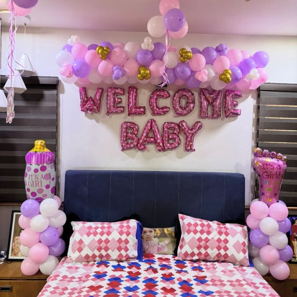Pink and purple theme bedroom balloon decor in Jaipur with Welcome Baby foil letters and baby bottle balloons by Shava Moments.